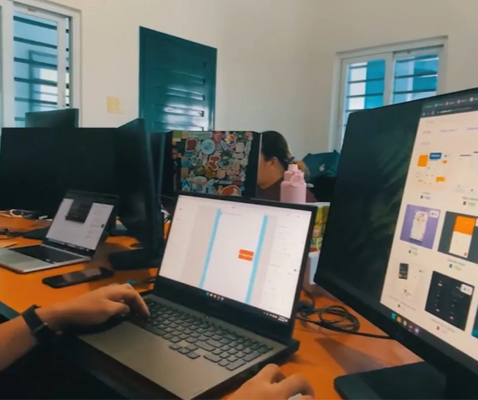 Work area displaying laptops and external monitor at MPH's office in PH