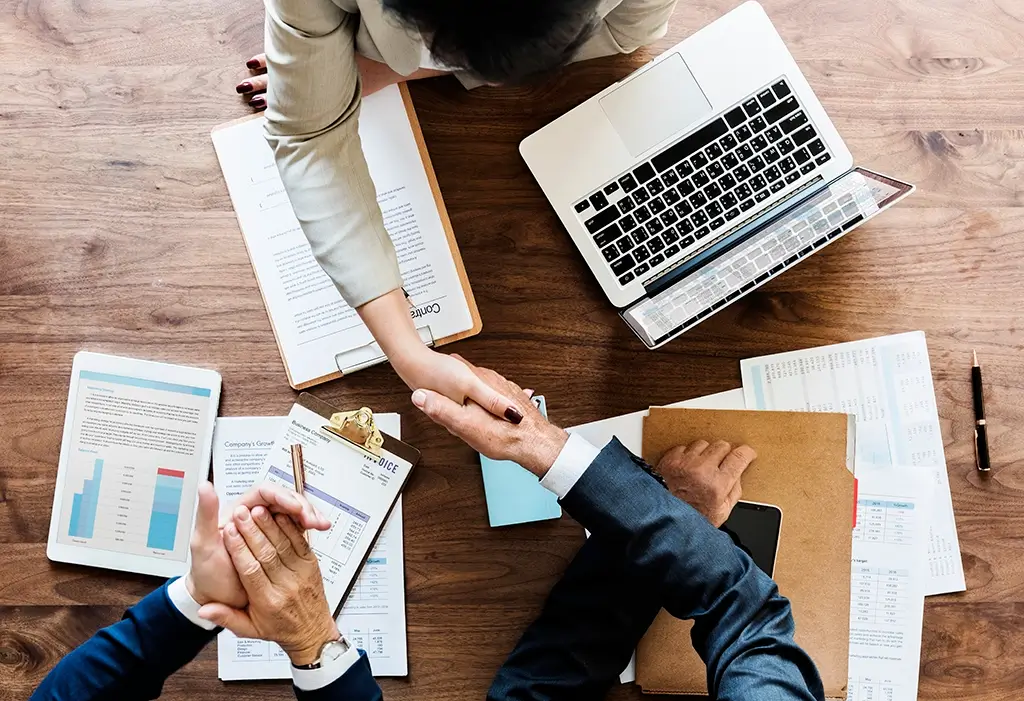 business people shaking hands together