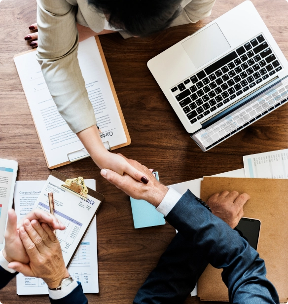 Image of a meeting top perspective with people shaking hands