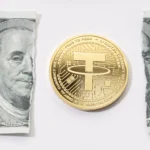 A tether coin placed in the middle of a ripped one-dollar bill.