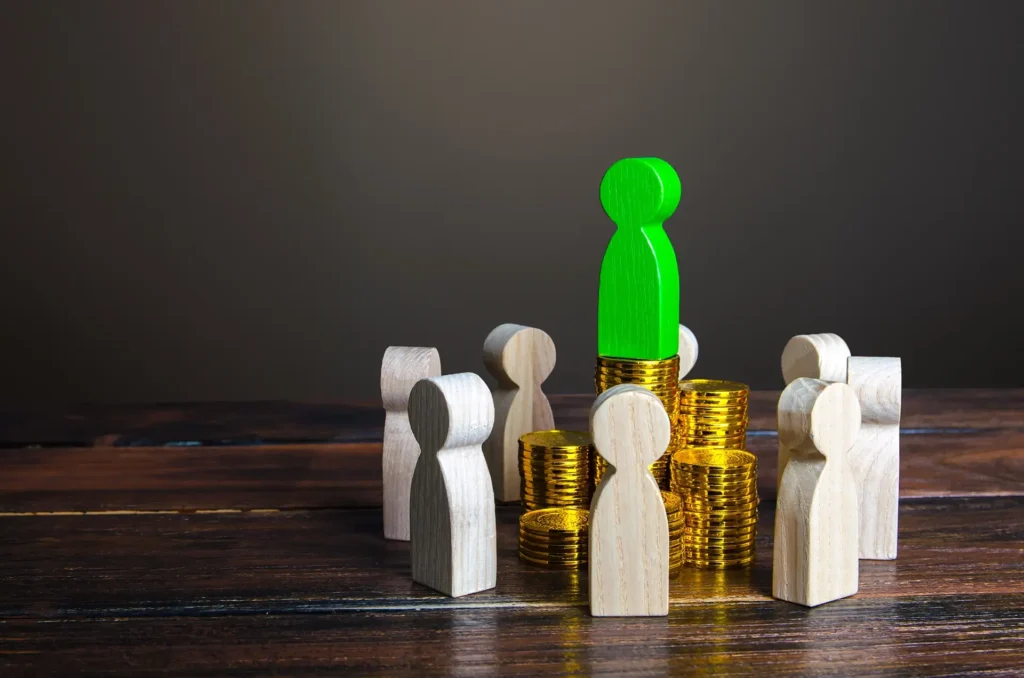 A green figure stands triumphantly atop a large pile of gold coins, symbolizing wealth and success.