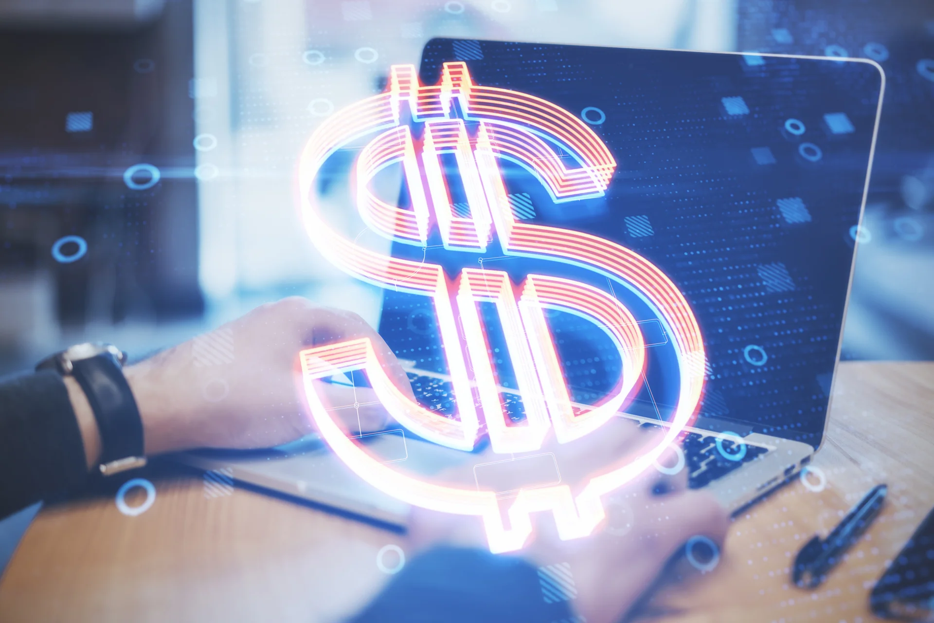 Hands type on a laptop with a large, glowing digital dollar sign overlay. The image conveys themes of online finance and technology.